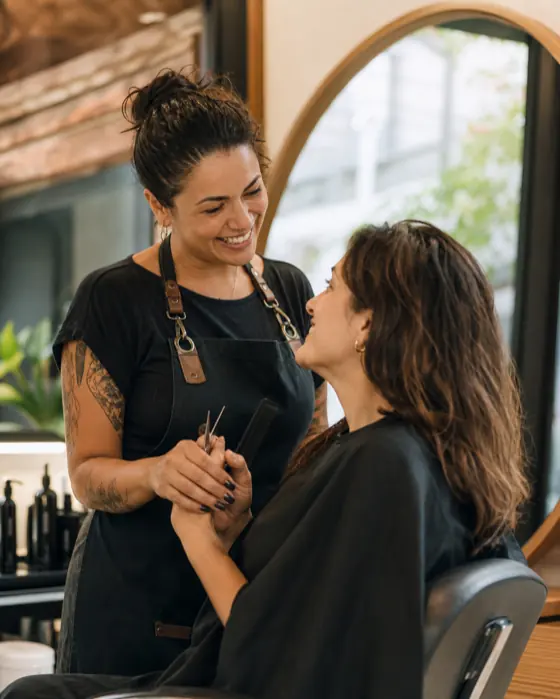 Profissional e cliente conversando durante o atendimento no salão